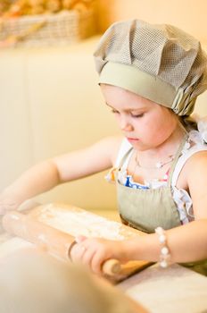 Little girl start cooking pizza and working with dough