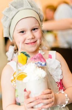 Little girl with hand made milk cocktail with decorations