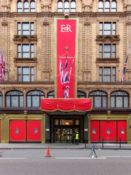 LONDON, UK - MAY 15: Workers put the last touch to the special Queen's Diamond Jubilee decoration on Harrods facade on May 15, 2012 in London.