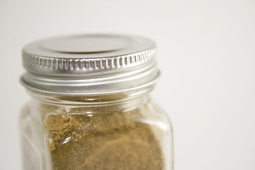 Close up of spice jar on white background