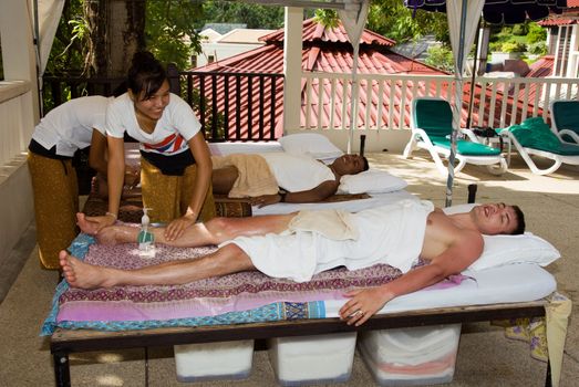 Men get a Thai massage. Thailand, Phuket, Patong.