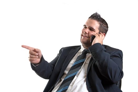 yound businessman is pointing and talking over the cellphone, isolated on white background