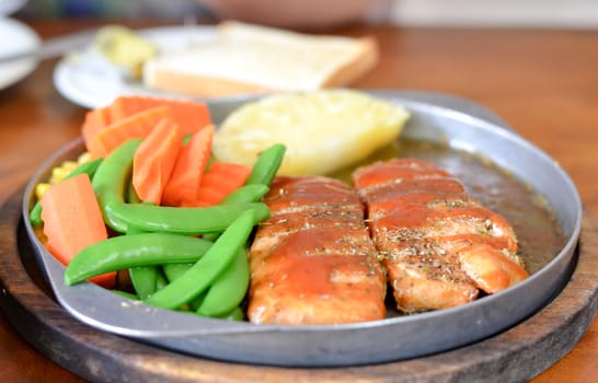 roasted fish  and tomato sauce served with vegetable
