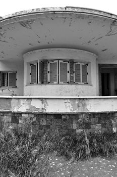 Futuristic house from the 1960s abandoned in ruin. Round roof and porch detail.
