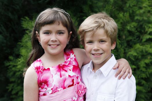 Brother and sister outdoors smiling