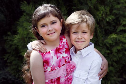 Brother and sister outdoors smiling