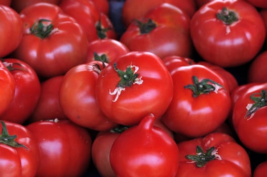 Ripe red tomatoes for sale at grocery store. Vegetables background.