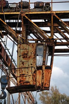 Rusty industrial machinery at abandoned marble processing factory.