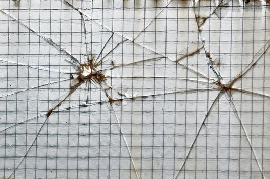 Smashed glass reinforced with wire squares background texture.