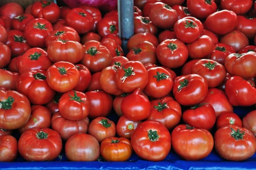 Fresh tomatoes for sale at grocery store. Vegetables background.