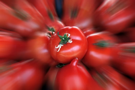 Tomatoes at grocery store. Vegetables blur background.