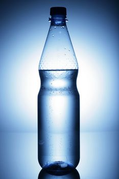 water bottle on a shiny surface in studio