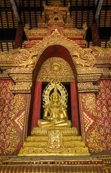 Golden Buddha in church at Phra Singh Temple, Chiang Mai, Northern Thailand