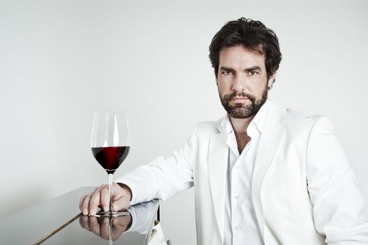 An image of a handsome man and a glass of red wine