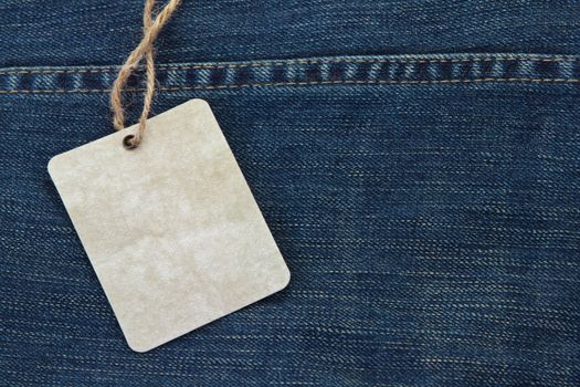 Price tag over jeans background