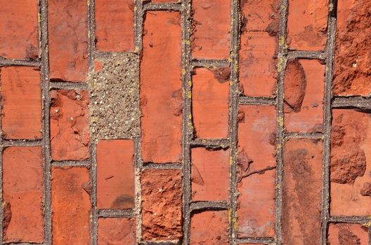 Fragment of old squared red brick wall.