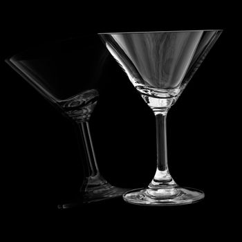 Empty cocktail glass on black background and reflect