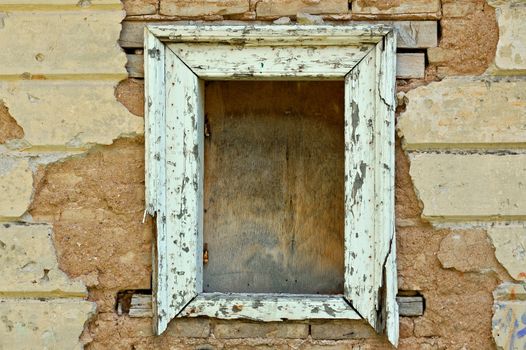 Empty wooden window frame and chipped wall texture. Grunge background.