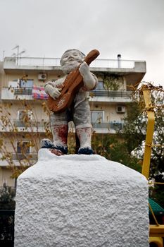 Vintage weathered decorative garden gnome with guitar. Urban serenade.