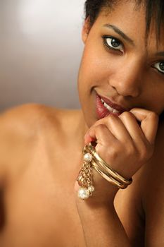 Photo of the face of a beautiful black woman in her twenties. Shallow depth of field, focusing on the eyes.