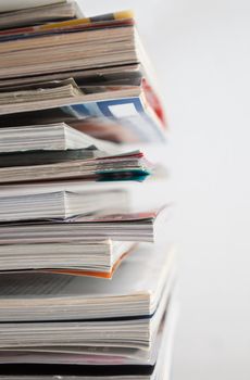 Close up image of several magazines and books