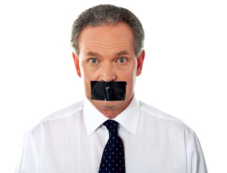 Portrait of matured businessman with duct tape on his mouth