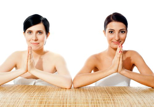 Two pretty ladies posing in traditional welcoming gesture