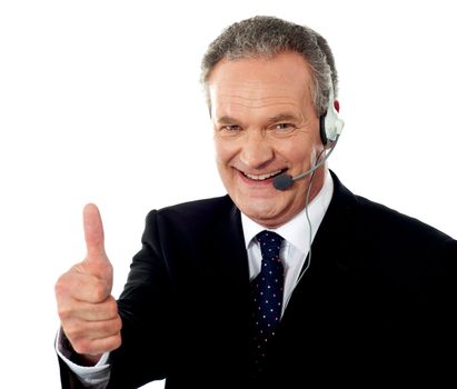 Call centre executive smiling with thumbs-up gesture isolated over whte background