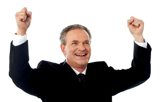 Successful old businessman rejoicing in excitement with arms up