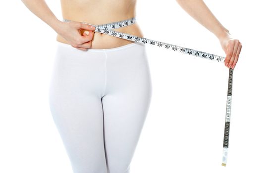 Woman measuring her abdomen with metre isolated over white background