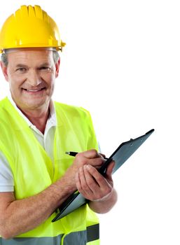 Cropped image of an aged architect writing on documents