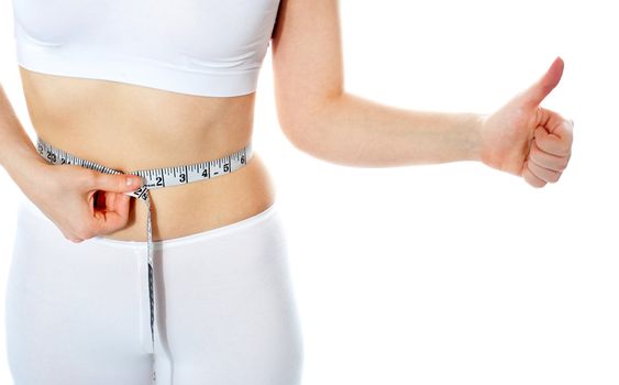 Closeup of tape measure around woman waist. Isolated. Thumbs-up gesture