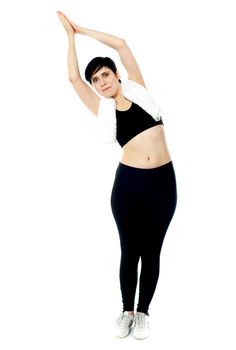 Fit female instructor doing stretching exercise isolated over white
