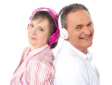 Romantic couple posing back to back listening to music