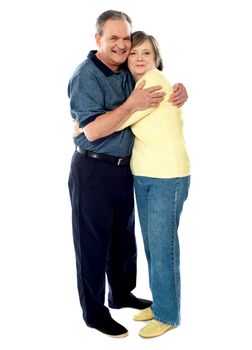 Aged smiling couple hugging each other on white background