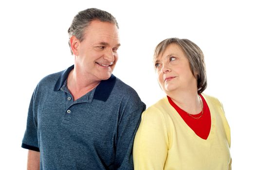 Attractive senior couple being playful. Posing back to back