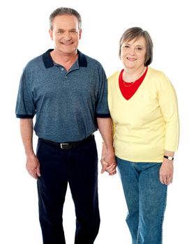 Happy matured couple posing with hands held together