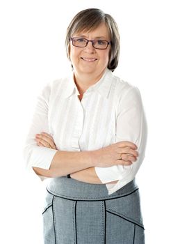 Smiling attractive old lady posing with arms crossed isolated over white