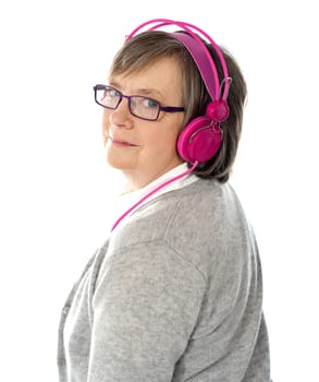 Woman listening music looking back at camera