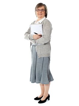 Full length portriat of an aged woman carrying business documents. Isolated on white background