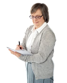 Portrait of a businesswoman writing notes isolated on white background