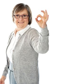 Old lady showing excellent gesture against white background
