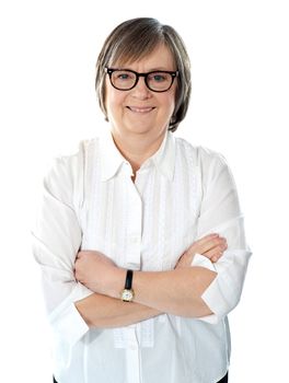 Senior female business executive in white shirt posing with crossed arms