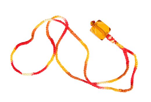 Pendant in the form of a transparent cube on the braided line yarn on a white background