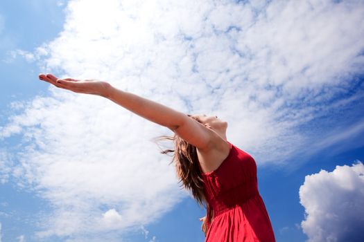 Girl with open arms to the sky