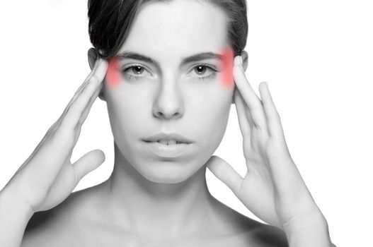 Woman suffering from an headache, holding her hands to the head