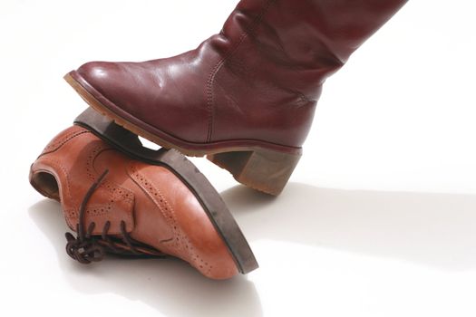 Close-Up of a boot standing on another leather shoe