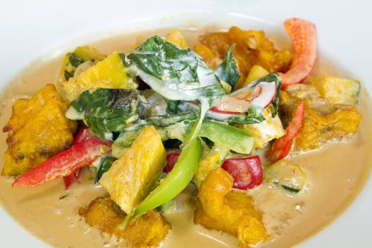 Thai Friend Salmon Fish Fillet in Red Curry with Basil Leaves Pumpkin and Bell Peppers Closeup