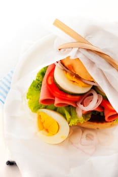 Baked garlic ciabatta sandwich with fresh salad tomato onion egg and sausage as supplement