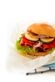 Baked garlic ciabatta sandwich with fresh salad tomato onion egg and sausage as supplement